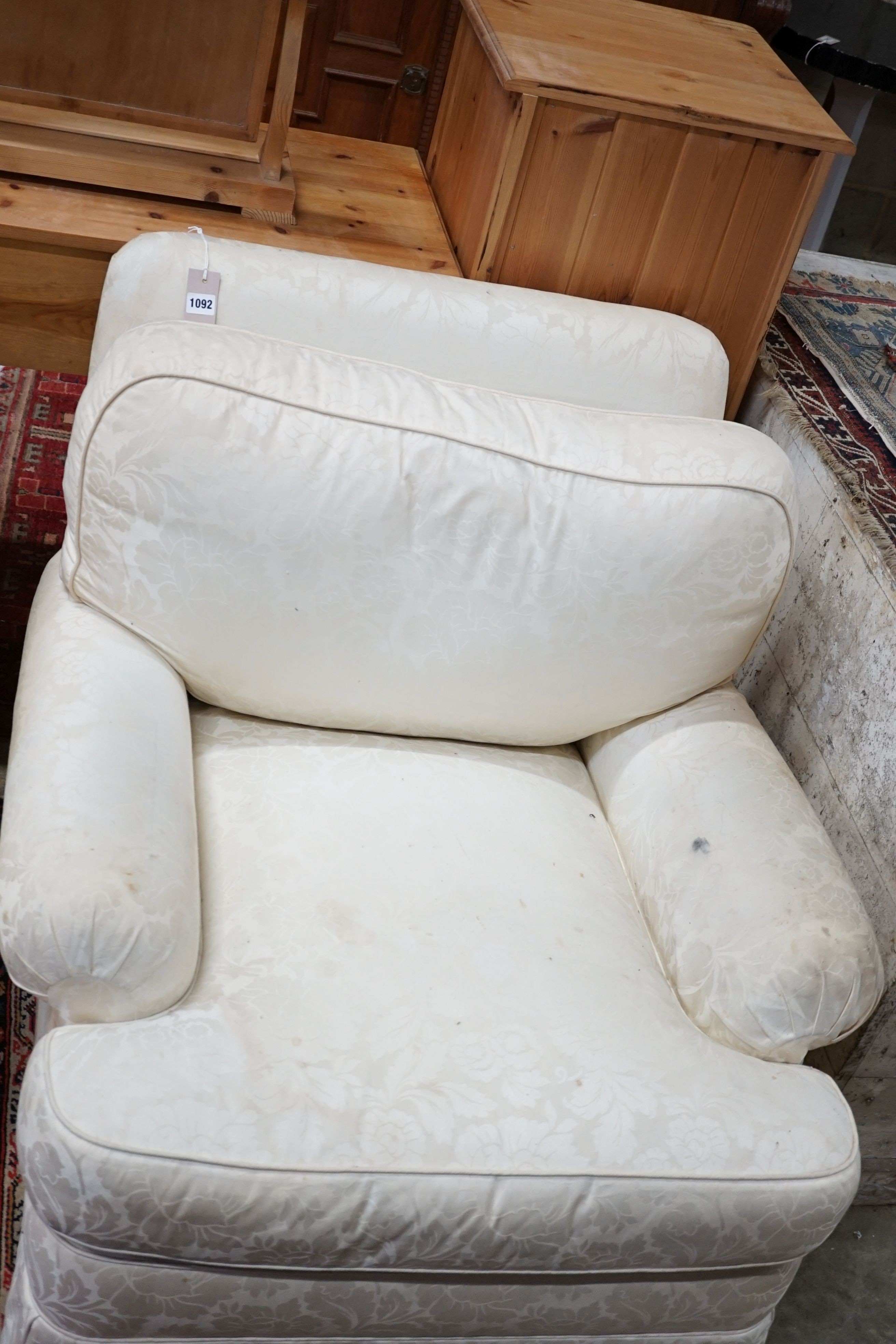 A brown leather upholstered desk chair, a mahogany hall chair and two upholstered armchairs